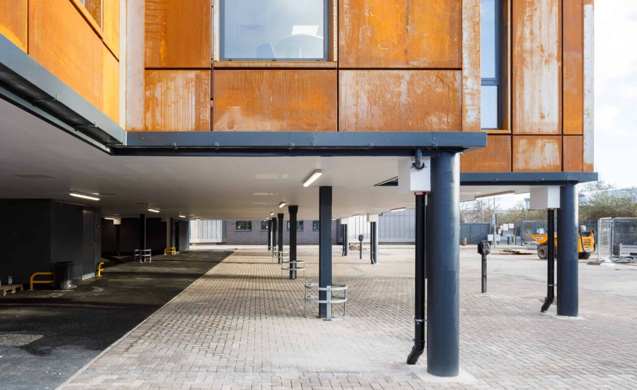 Close up of underneath Leeds City College new modular building. The building was built onto podiums to allow for parking spaces beneath the modular classrooms.